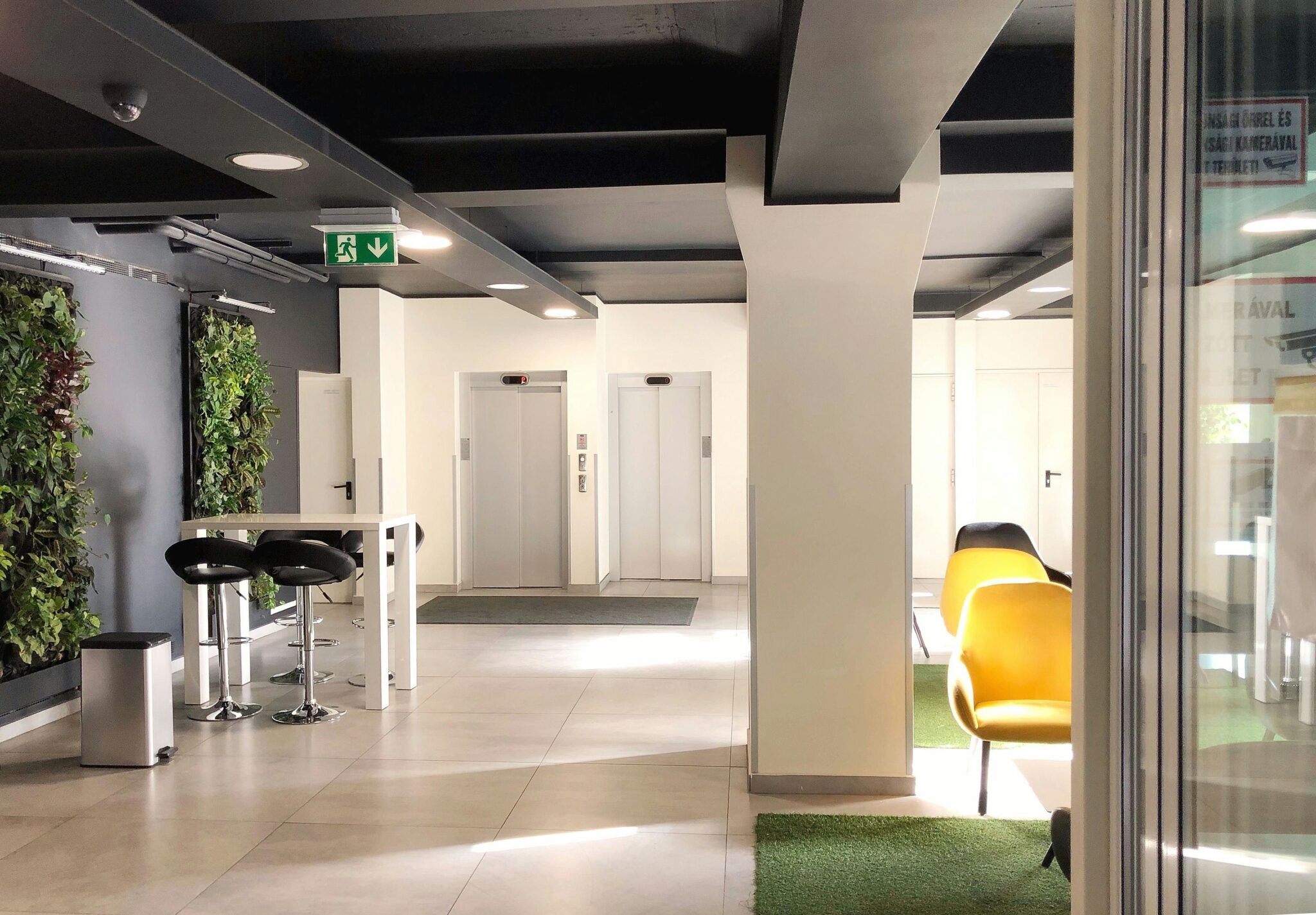 Finished commercial building lobby with elevators and interior glazing
