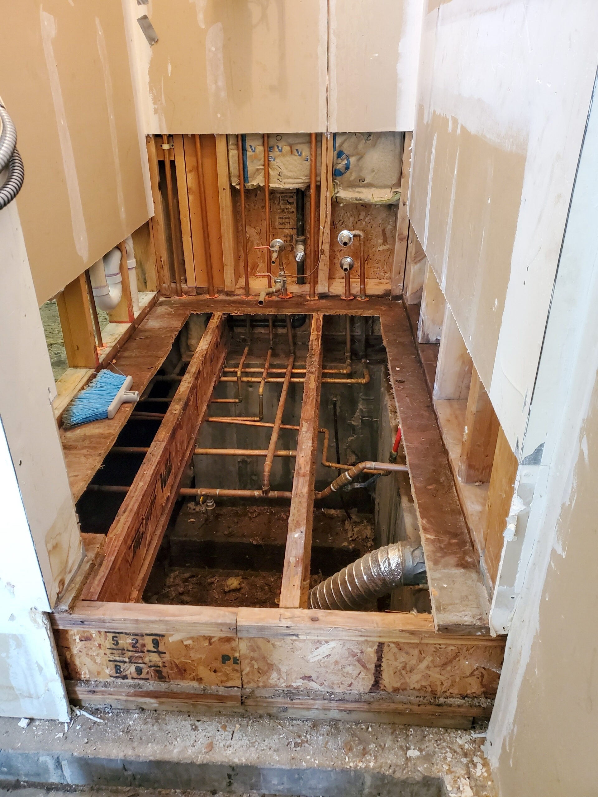 The subfloor in this bathroom was removed due to heavy damage from a water loss.