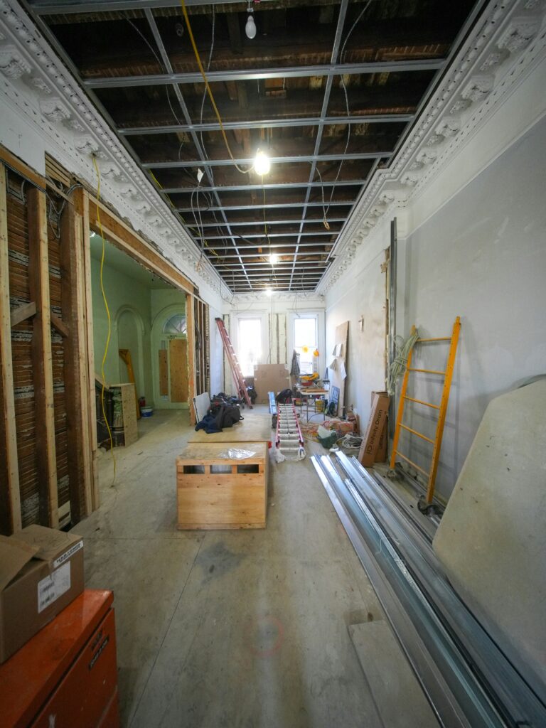 Tacoma general contractor crew on a commercial interior renovation with ladders, materials, and exposed wall framing